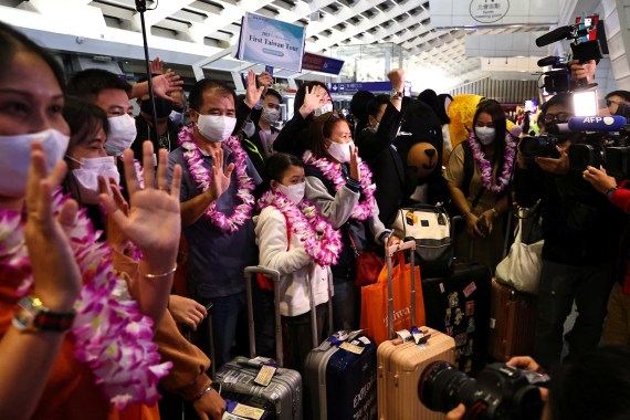 Group of visitors at Taiwan airport, wearing masks