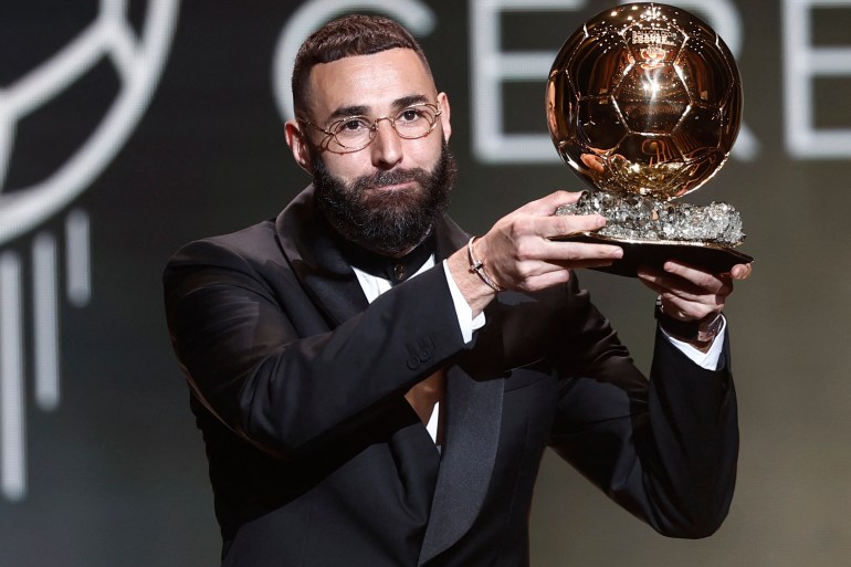Real Madrid's Karim Benzema holding up the Ballon d'Or.
