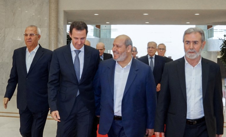 Syria's President Bashar al-Assad meets with Hamas politburo member Khalil al-Hayya in Damascus, Syria, in this handout released by SANA on October 19, 2022.