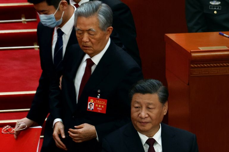 Former Chinese president Hu Jintao leaves his seat next to Chinese President Xi Jinping during the closing ceremony of the 20th National Congress of the Communist Party of China, at the Great Hall of the People in Beijing, China October 22, 2022
