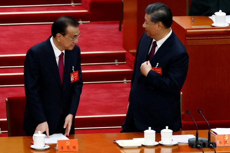 Chinese President Xi Jinping and Premier Li Keqiang leave at the end of the closing ceremony of the 20th National Congress of the Communist Party of China, at the Great Hall of the People in Beijing, China October 22, 2022