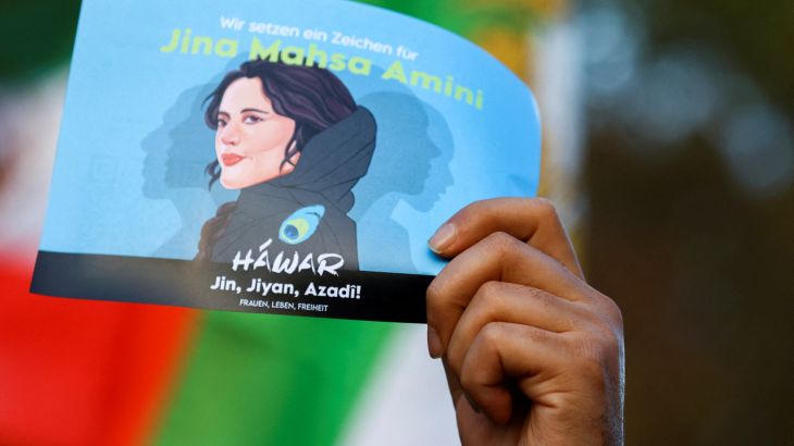 A demonstrator holds a poster during a protest following the death of Mahsa Amini in Iran, in Berlin, Germany, October, 22, 2022.