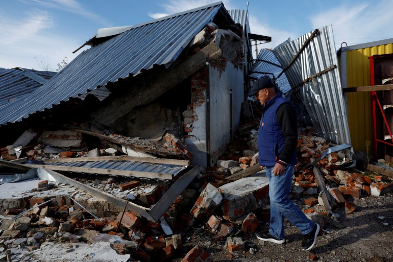 Victor walks across the forecourt of his garage which was completely destroyed during Russian strikes, amid Russia's attack on Ukraine, in Balakliia, Ukraine, October 22, 2022. REUTERS/Clodagh Kilcoyne TPX IMAGES OF THE DAY