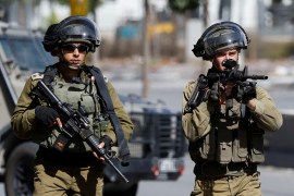 Two Israeli soldiers with guns