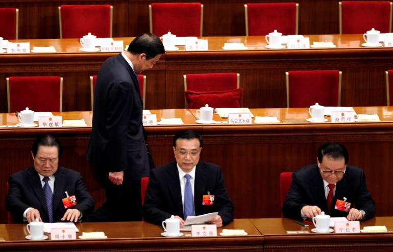 Chongqing party secretary Bo Xilai, past other Chinese leaders from left, Zhou Yong Kang, head of the Chinese Political and Legislative Committee of the Communist Party, Vice Premier Li Keqiang and propaganda chief Li Changchun in the Great Hall of the People.  Zhou was later found guilty of corruption as well