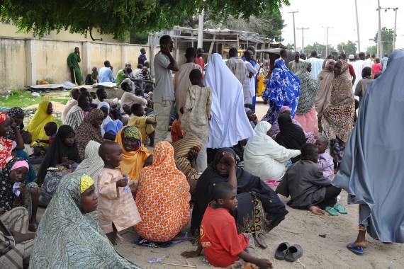 FILE- In this Wednesday, Sept. 3, 2014 file photo, Civilians who fled their homes following an attacked by Islamist militants in Bama, take refuge at a School in Maiduguri, Nigeria.