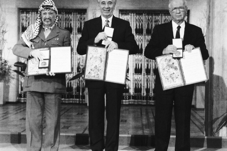 PLO leader Yasser Arafat, Israeli Prime Minister Yitzhak Rabin and Israeli Foreign Minister Shimon Peres pose with their medals and diplomas, after receiving the 1994 Nobel Peace Prize in Oslo