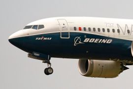 Front of Boeing jet in the air with front wheel out
