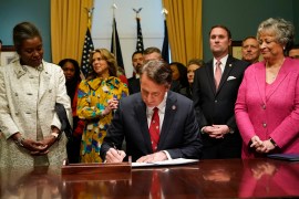 Virginia Governor Glenn Youngkin, centre, seen here signing executive orders on January 15, 2022, ordered a review aimed at rooting out critical race theory in schools, in his first decision after taking office in January. (Steve Helber/AP Photo)