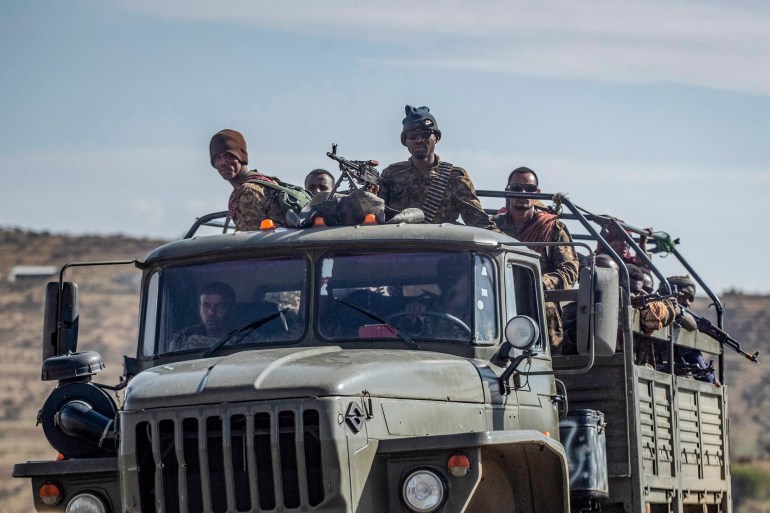 FILE - Ethiopian government soldiers ride in the back of a truck on a road near Agula, north of Mekele, in the Tigray region of northern Ethiopia