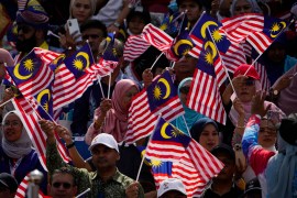 Malaysians waving the national flag during independence day celebrations