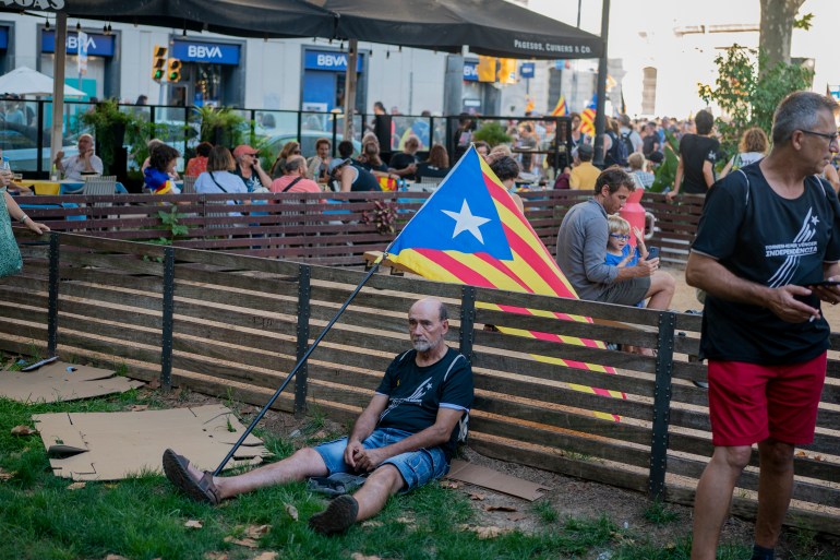 Protesters hold esteladas or independence flags as they take part in a demonstration during the Catalan National Day in Barcelona, Spain