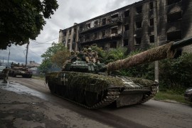 Ukrainian servicemen drive a tank in the recently retaken area of Izyum, Ukraine [File: Evgeniy Maloletka/AP Photo]