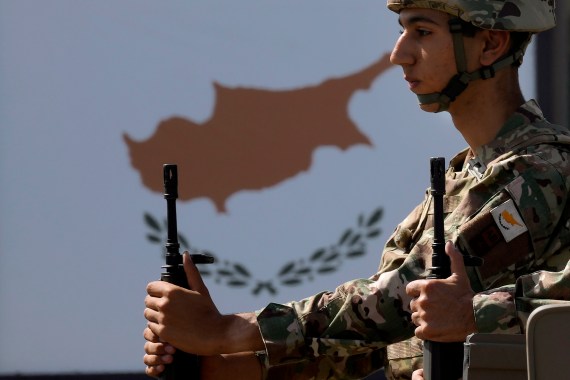 A Cypriot soldier sits on a truck during a military parade marking the 62nd anniversary of Cyprus' independence from British colonial rule, in Nicosia, Cyprus