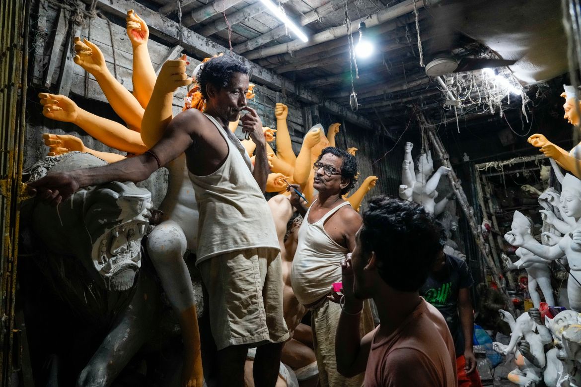 Artisans work on idols of Hindu goddess Durga ahead of Durga Puja festival at Kumortuli, the potters' place, in Kolkata,