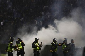 Police officers fire tear gas during clashes at Kanjuruhan Stadium in Malang, East Java, Indonesia. [Yudha Prabowo/AP Photo]