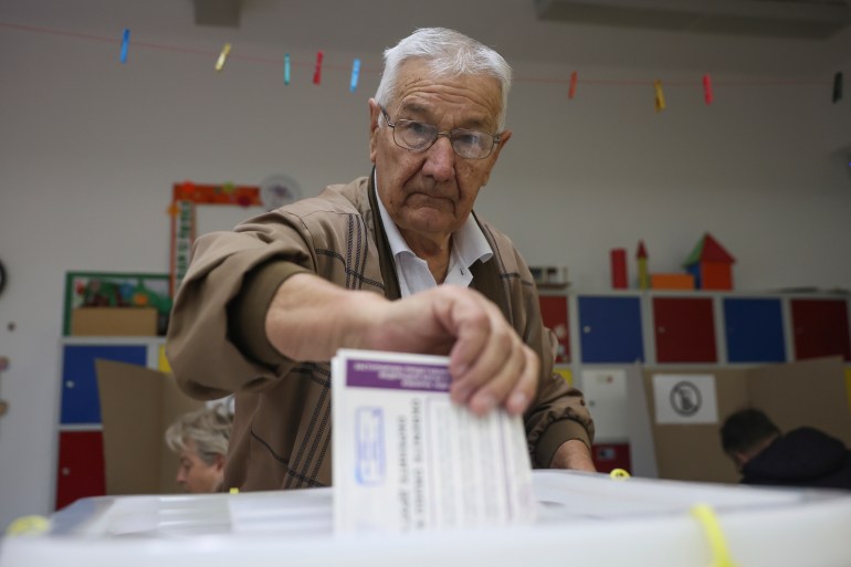 Bosnian man casts his vote at a poling station in Sarajevo, Bosnia