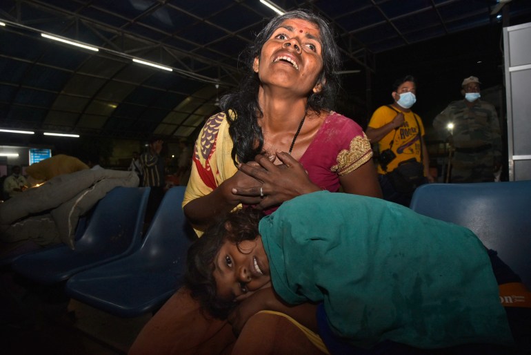 Victims of a farm tractor crash cry in hospital in Kanpur, 100 kilometers (62 miles) southwest of Lucknow, capital of the Indian state of Uttar Pradesh, Sunday, Oct. 2022. Twenty-six people, mostly women and children, were killed when a farm tractor pulling an overnight passenger wagon overturned and fell into a pond in the northern Indian state of Uttar Pradesh, officials said Sunday.  (AP Photo)