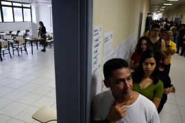 Voters line up during the general elections in Brasilia, Brazil [Eraldo Peres/AP Photo]