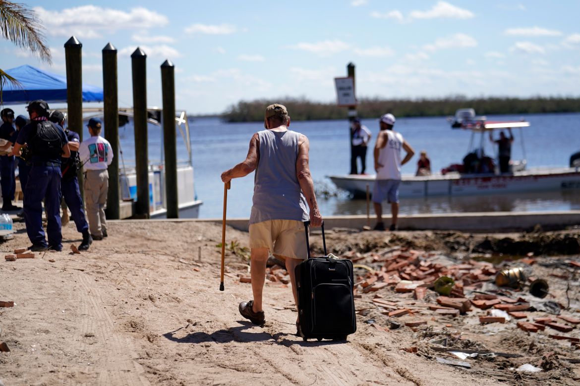 Residents who rode out the storm arrive at a dock to evacuate by boat in the aftermath of Hurricane Ian, on Pine Island in Florida's Lee County