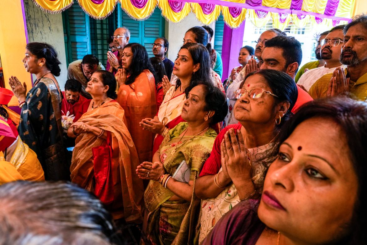 Devotees pray before an idol of Hindu goddess Durga on the second day of Durga Puja festival in Kolkata