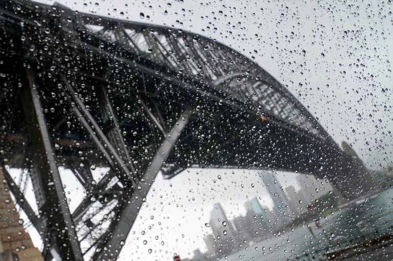 Sydney Harbour Bridge and the city seen through a rain-covered window