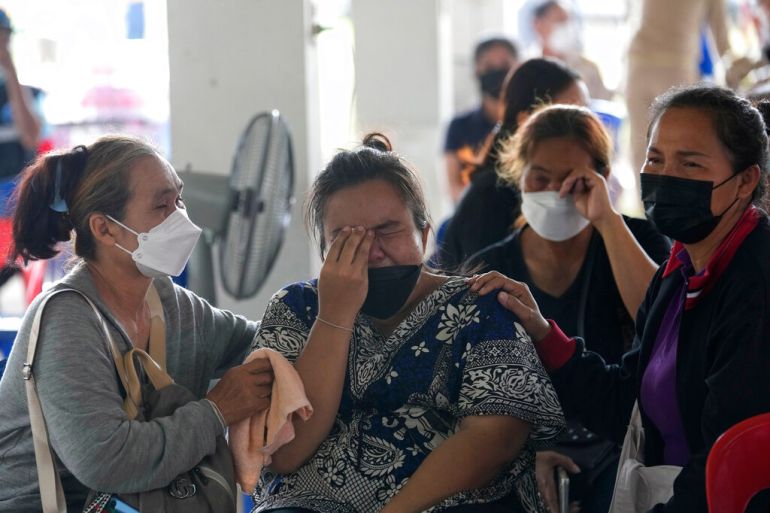 Relatives of victims cry outside the daycare centre in Uthai Sawan town that was attacked in northeastern Thailand