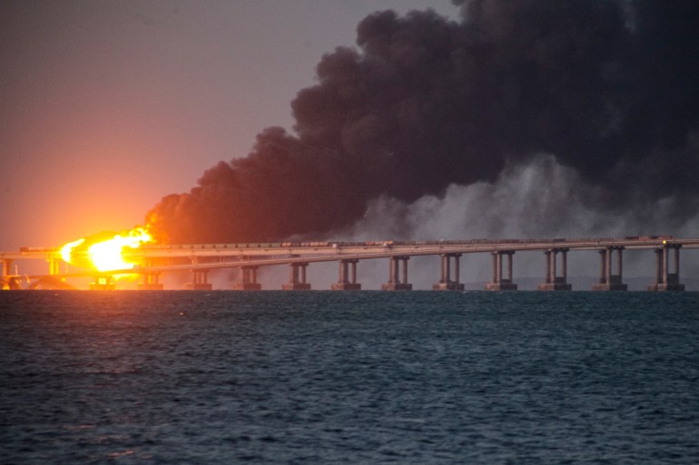 Flame and smoke rise from the Crimean bridge connecting Russian mainland and Crimean Peninsula over the Kerch Strait