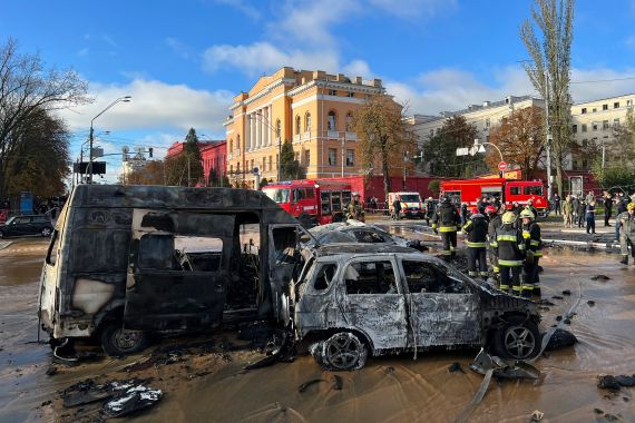 Rescue workers survey the scene of a Russian attack on Kyiv, Ukraine