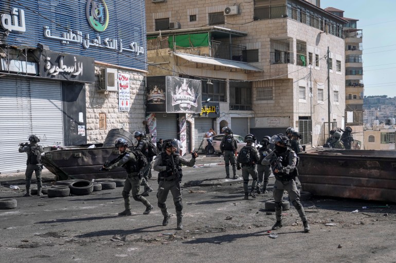 Israeli security forces conduct a search the Palestinian Shuafat refugee camp