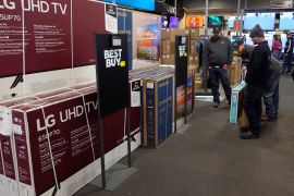 Customers debate on a television selection at Best Buy in Indianapolis, US
