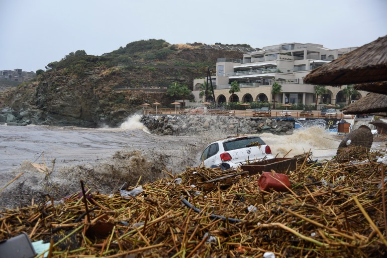 A view of an abandoned car near the sea after torrential rainfall in the village of Agia Pelagia, on the island of Crete, Greece, Saturday, Oct. 15, 2022. It has been reported that at least one person has died with others missing due to the severe flooding. (AP Photo/Harry Nakos)