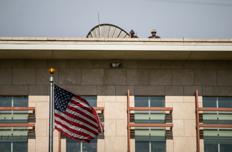 US soldiers stand guard on the roof of the US Embassy as they watch a protest to reject an international military force requested by the government and to demand the resignation of Prime Minister Ariel Henry, in Port-au-Prince, Haiti, Monday, Oct. 17, 2022