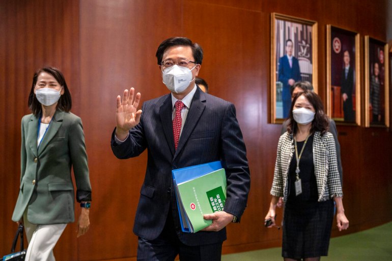 Hong Kong Chief Executive John Lee waves as he enters the chamber of the Legislative Council in Hong Kong.