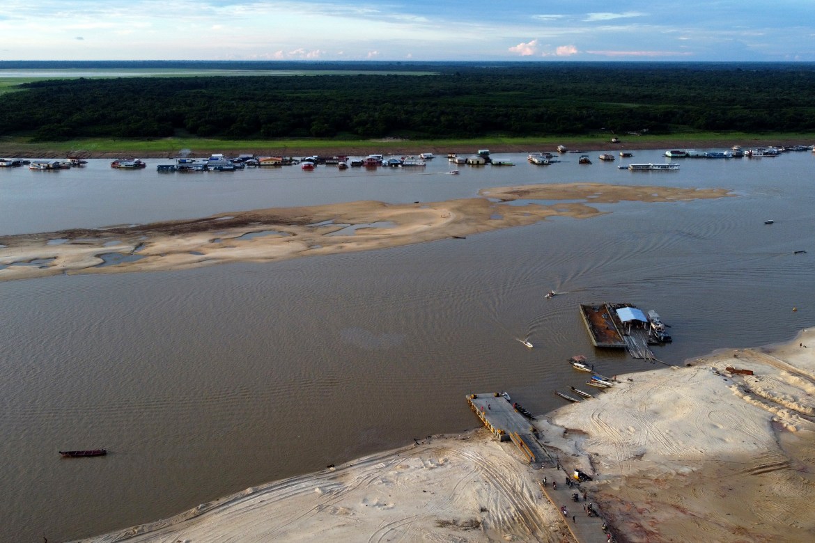 A boat dock sits amid drought-impacted land near the Solimões River, in Tefe, Amazonas state, Brazil