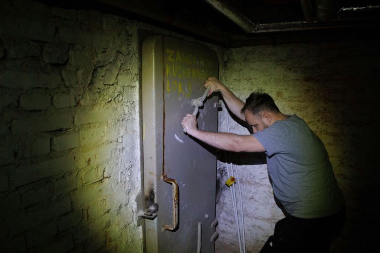 Jacek, 37, a local resident, closes a door to a shelter in the basement of a residential building in Warsaw, Poland, Wednesday, Oct. 19, 2022. Fighting around Ukraine's nuclear power plants and Russia's threats to use nuclear weapons have reawakened nuclear fears in Europe. This is especially felt in countries near Ukraine, like Poland, where the government this month ordered an inventory of the country's shelters as a precaution. (AP Photo/Michal Dyjuk)