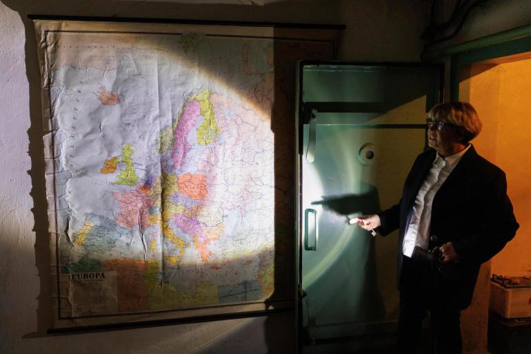 Ewa Karpinska, spokesman for the ArcelorMittal Warsaw steel plant, shows an old map in a Cold War air raid shelter under the plant in Warsaw, Poland, Thursday, October 20, 2022. Fighting around Ukraine's nuclear power plants and Russia's threat to use nuclear weapons have reawaken nuclear fear in Europe.  This is particularly noticeable in countries close to Ukraine, such as Poland, where the government this month ordered a precautionary inventory of the country's shelters.  (AP Photo/Michal Dyjuk)