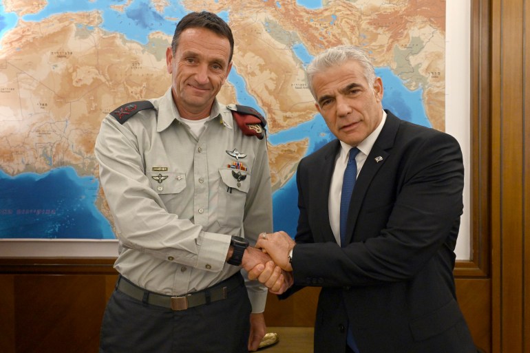 Israeli Prime Minister Yair Lapid, right, poses for a photo with Israel's next military chief Maj. Gen. Herzi Halevi