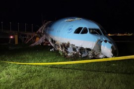 A damaged portion of the Korean Air Lines plane lies after it overshot the runway at the Mactan Cebu International Airport in Cebu, central Philippines, on Monday.
