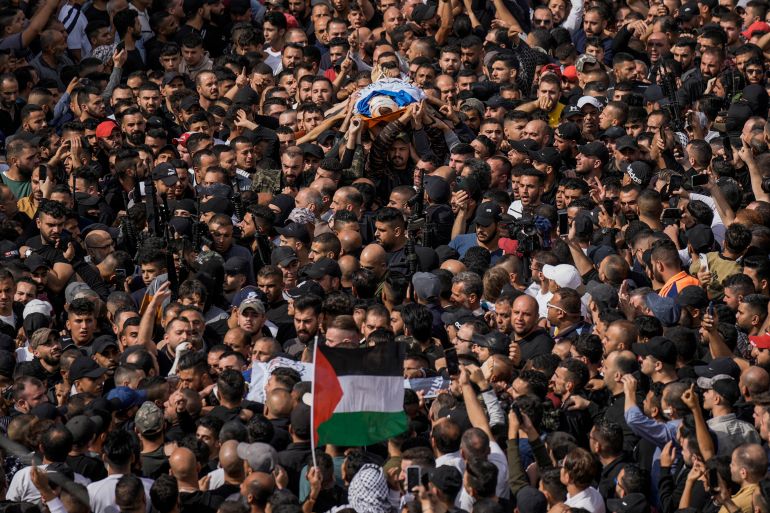 Mourners carry the bodies of Palestinians who were among five killed in an overnight Israeli raid, during their funeral in the occupied West Bank city of Nablus