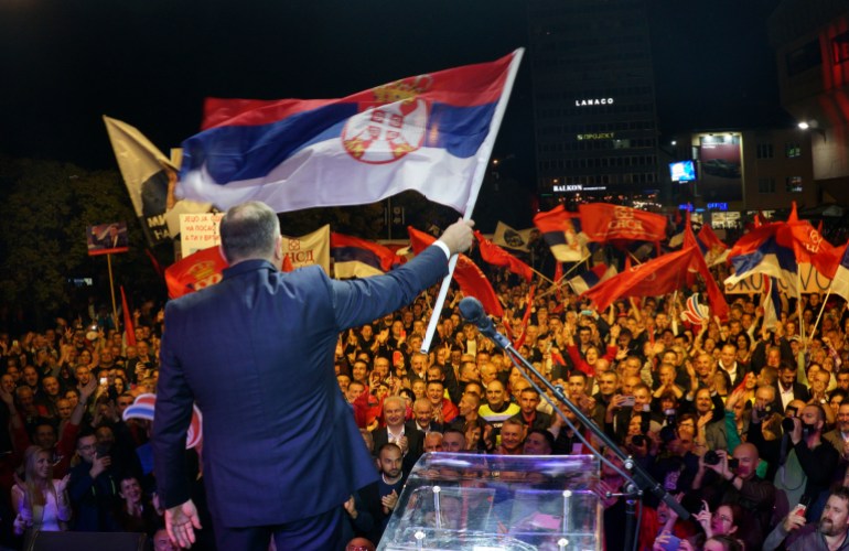 Bosnian Serb leader Milorad Dodik waves a Serbian flag during a protest against state election commission of Bosnia, which is likely to announce a re-run of presidential elections following allegations of fraud in favor of Dodik in the Bosnian town of Banja Luka, 240 kms northwest of Sarajevo, Tuesday, Oct. 25, 2022. Opposition leaders claim that their candidate Jelena Trivic is the winner, and that Dodik rigged the ballot. (AP Photo/Radivoje Pavicic)