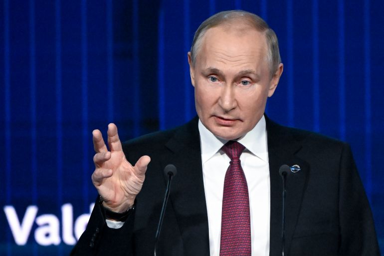 Russian President Vladimir Putin gestures as he speaks