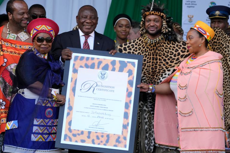South Africa's President Cyril Ramaphosa hands over a certificate of recognition to King Misuzulu ka Zwelithini