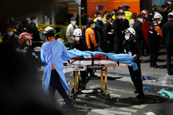 Rescue workers carry a victim on the street near the scene in Seoul, South Korea.