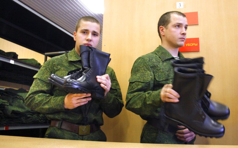 Russian military conscripts receive uniform boots at a conscription point in downtown Moscow, Russia in 2010 [File: Mikhail Metzel/AP]