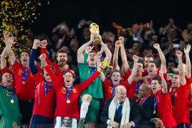 Iker Casillas Captain of Spain celebrates with the trophy after being handed it by Sepp Blatter, FIFA President and Jacob Zuma President of South Africa and surrounded by the Spanish team after victory in the World Cup Final
