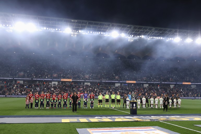 Players line up for the Australian national anthem during the Australia Cup Final match between Sydney United 58 FC and Macarthur FC at Allianz Stadium on October 01, 2022 in Sydney