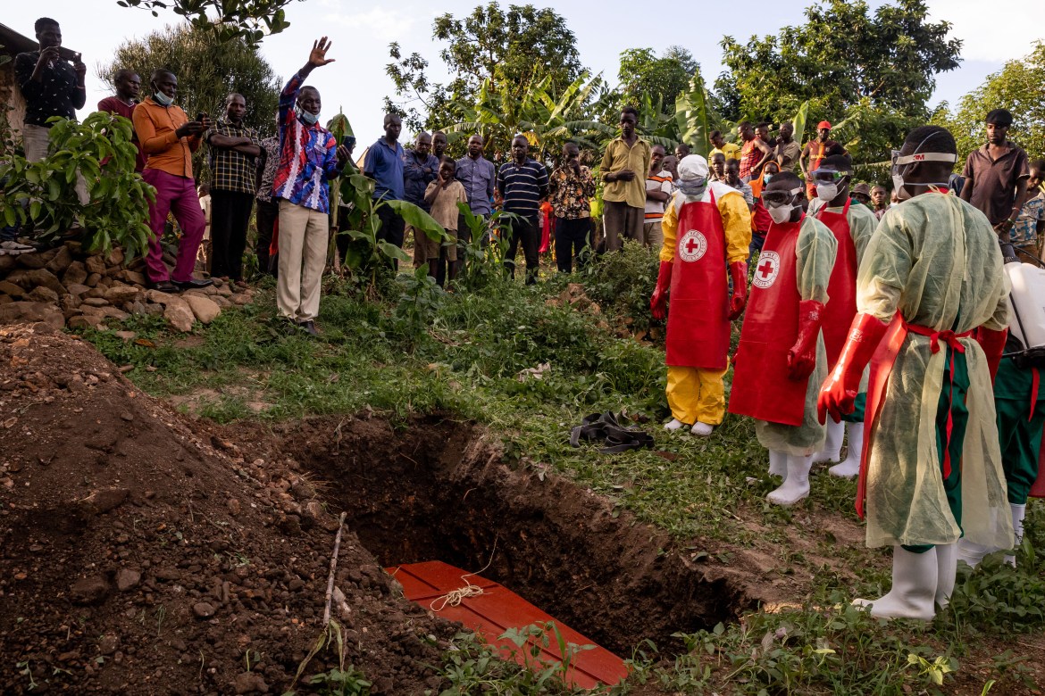 A prayer is read during a Safe and Dignified Burial of an Ebola victim