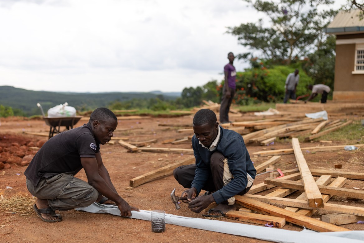 Construction workers build a makeshift Ebola Treatment Unit