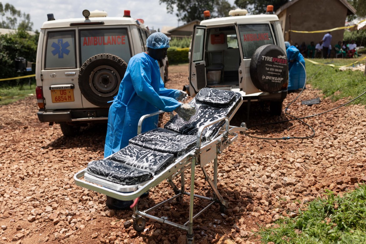 Red Cross workers clean ambulances prior to transporting Ebola victims to a hospita